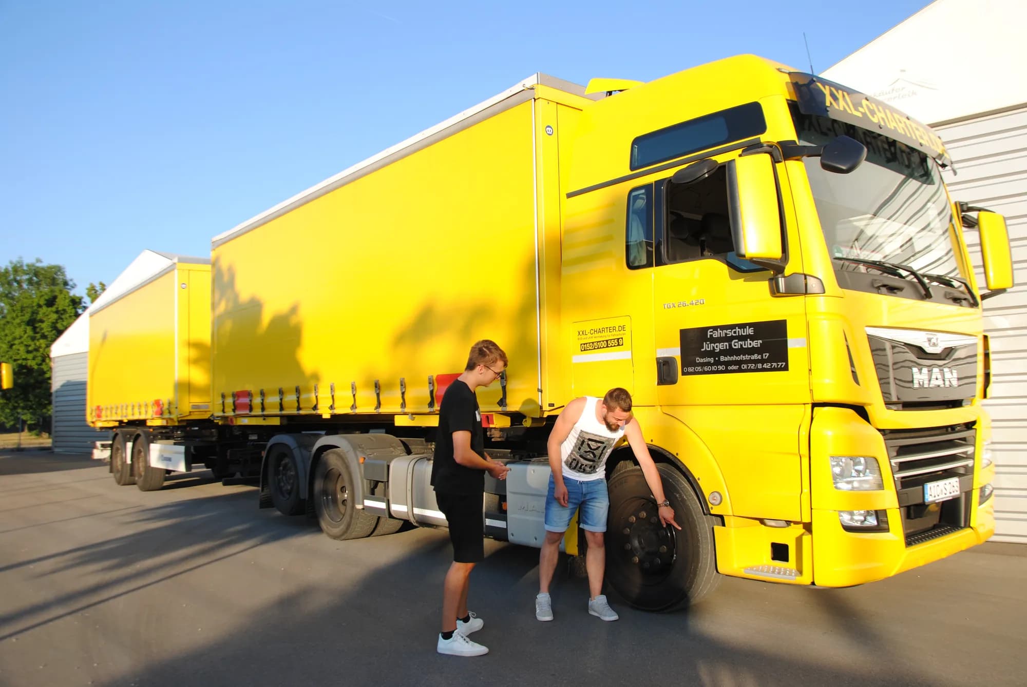 Gelber Schulungs-LKW der Fahrschule Jürgen Gruber mit Anhänger